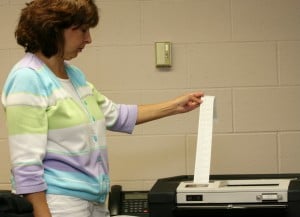 File photo. Chelsea City Clerk Terri Royal checks a tape generated by the Accu-vote computer during a public accuracy test.