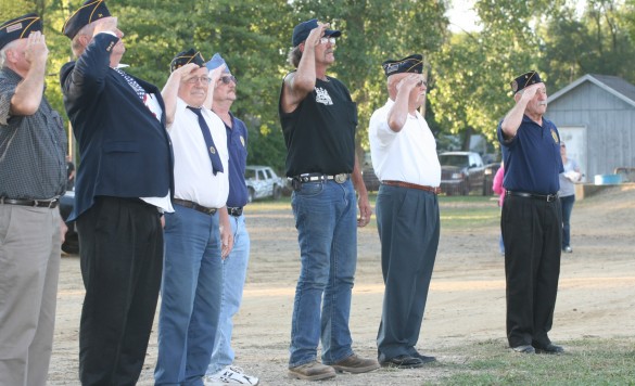 File photo. Members of the American Legion Post 31 salute the flag during the National Anthem.