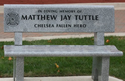 The memorial bench for Matt Tuttle in front of the library.