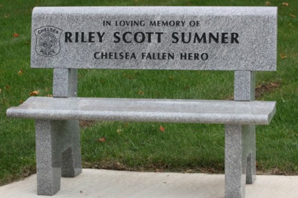The memorial bench for Scott Sumner in front of the library.