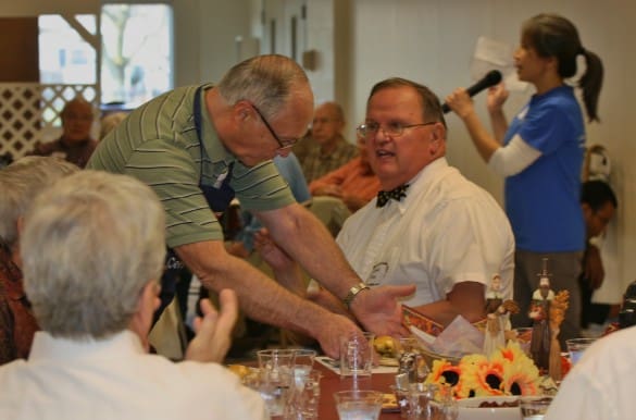 File photo. Kiwanis Club Member Don Cole serves a meal.