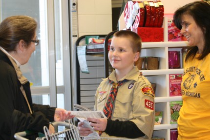 File photo. Riley Melody, 9, explains to a shopper what the scouts are doing during Scouting for Food, which benefits Faith in Action.