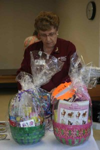 A hospital volunteer arranges some of the Easter baskets.