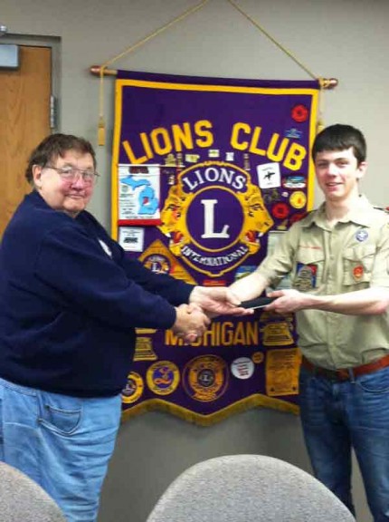 Courtesy photo. Lions Courtesy photo. Club member Paul Weber and Eagle Scout candidate 