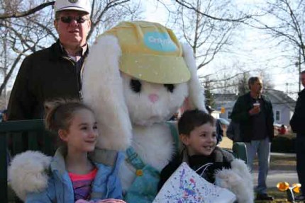 Ray Kemner, chairman of the event stands behind the Easter Bunny and two children. 