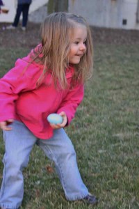 Little girl finds an egg in the Chelsea Retirement Community courtyard.