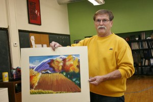 Kerry Kargil holds a piece of high school art. 