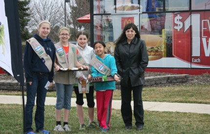 Some of the Chelsea Girl Scouts and Anita Mosier pose outside the Chelsea McDonald's for a photo.
