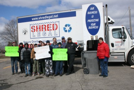 A group photo of the scouts and helpers during a secure document shredding fundraiser. 