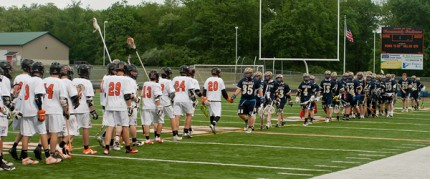 Courtesy photo. Tecumseh and Chelsea lacrosse players shake hand.