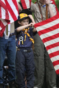 A scout holds the American flag.