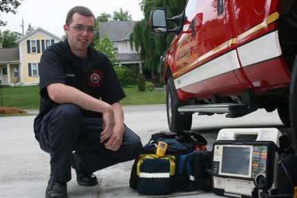 Firefighter Bill Regnier poses with Squad 1, the vehicle that usually goes out on medical calls, the medical bag with the new CO detector and a defibrillator. 