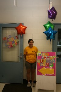 Camp counselor Krista Bradley poses outside the door to the Wild About Summer Camp space. 