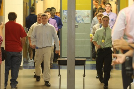 Class President Lee Angir (on left) and Vice President Nick Beatty (on right) lead the 200 eighth-graders into the gym at Beach Middle School.