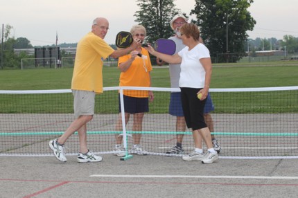 At the end of a game, all players touch racquets.