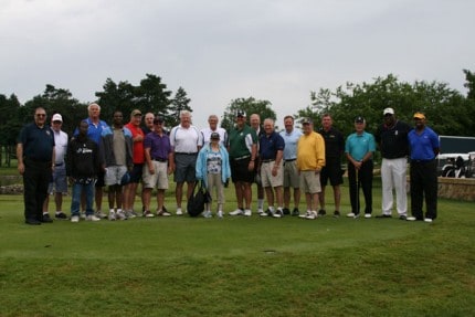 Courtesy photo. Fr. Enzo and residents Antoine, Stefan, and Lisa pose for the Celebrity group photo with Judge George Economy of Lansing, Paul Seymour (Detroit/Buffalo), Tom Nowatzke (Detroit/Baltimore), George Goeddeke (Notre Dame/Denver), Ken Kal (Red Wings), Bill Dufek (UM), Peter Chryplewicz (Notre Dame/Detroit), Brett Petersmark (Dallas/Houston), Bill Wagner (Denver), Dick Honig (Big Ten Official), Mike Conlin (Big Ten Official), Jamie Nicholson (Big Ten Official), Gene Bolden (Oakland University AD – ret.), Dean Look (NFL Official), Reggie McKenzie (UM/Buffalo), and Sam Gash (Baltimore).