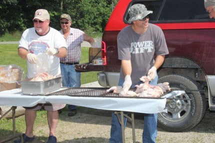 Legion members get the chicken ready for the BBQ pit.