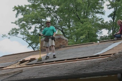 Tom Girard on the roof of his home before the roof was raised. 