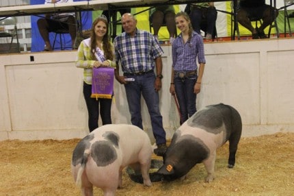 Amanda Breuninger and her grand champion pair of hogs.
