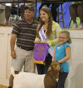 Kierstin Norris and her grand champion meat goat which sold for $250 to Staffan-Mitchell Funeral Home.