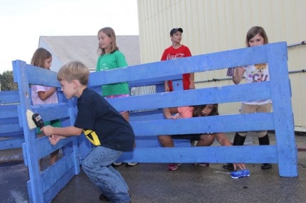 Young members of the Chelsea-Dexter Lamb Club scrub the panels that will become their lamb's pens.