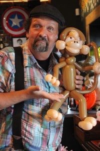 Balloon sculpturist John Charlton and his newest design, a monkey.