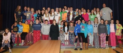 Sixth-greaders pose for a photo at lunch Wednesday in their PJs with Principal Nick Angel.