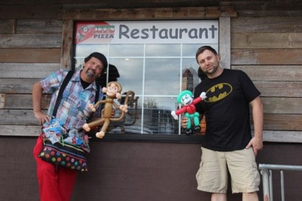 Outside Jet's Pizza, John Charlton, the balloon buffoon and Jason Povich, Jet's owner, pose with custom-made balloon sculptures. 