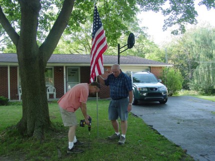 Courtesy photo. Lions Club members plant a flag in Chelsea.