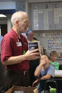 Kiwanian Bob Milbrodt tells third-grade students about their new dictionaries.