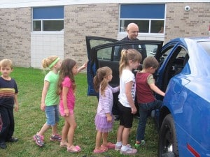 Kindergarten students tour a patrol car.