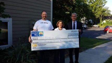 Courtesy photo. Nancy Paul from Faith in Action accepts a check from the United Way for $31,000.