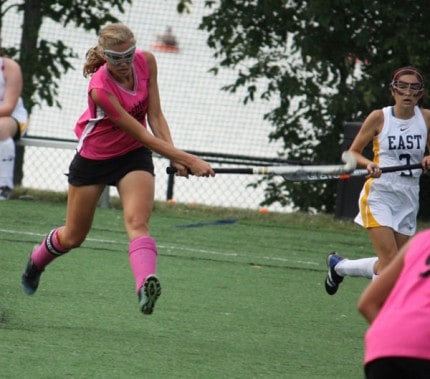 Courtesy photo by Sharon Kegerreis. Julia Porter, captain of the team, hits past East Grand Rapids' opponent. 