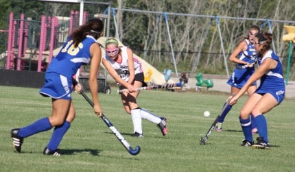 Courtesy photo by Sharon Kegerreis. Maggie Cole whips the ball between opponents.
