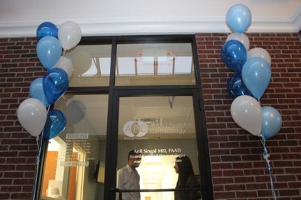 The front of the Adult and Pediatric Dermatology office in the Clocktower Commons. Dr. Anil Singal on left and his wife, Vu, on the right.