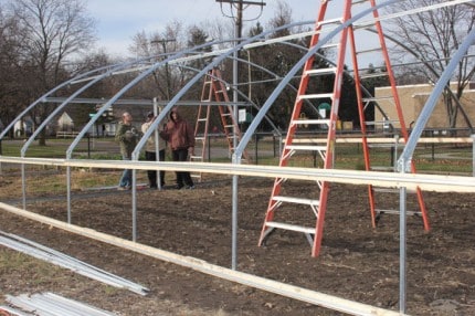 Clients from the Eisenhower Center work on the new hoop house at the Chelsea Area Senior Center.