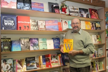 Just Imagine owner xxx holds Sue Grafton's new title.