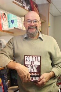 xxx holds local author John U. Bacon's new title, which would make a perfect Christmas gift for a football lover.