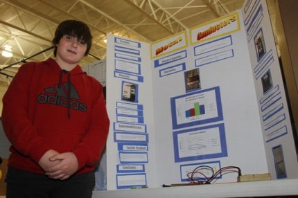 Riley Watkin poses with his science project.
