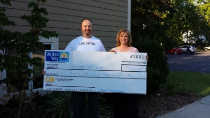 Courtesy photo. Eric Keaton, chairman of the Chelsea United Way Board and Dr. Diane Howlin of Grace Clinic with last year's check. 