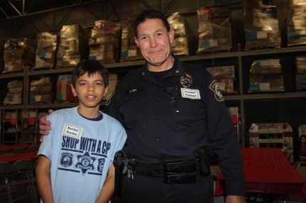 Chelsea Police Chief Ed Toth and his buddy for Shop with a Cop. 