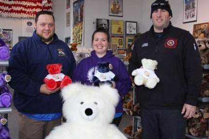 Ed Greenleaf, Murphy Payeru and Fire Lt. Scott Basar hold the special edition Teddy bears inside the Teddy Bear Factory. 