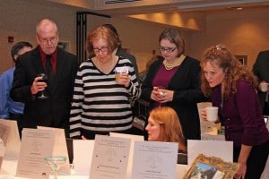 Participants check out some of the auction items at the Chelsea Education Foundation's recent gala.