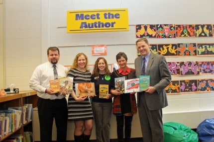 Author Sue Stauffacher (in red) and friends show off some of her books at North Creek Elementary.