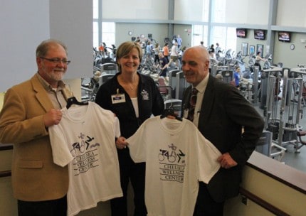 Bob pierce, executive director of the Chelsea Area Chamber of Commerce, Cindy Cope, director of the Chelsea Wellness Center and Bruce Szcodronski, president of the chamber with Wellness Center T-shirts during the business after hours event Thursday evening.