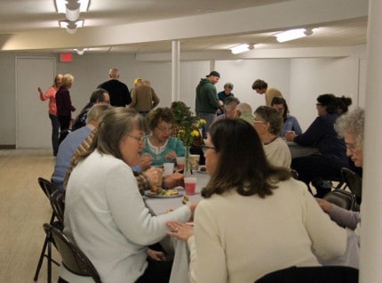 File photo. Members of the First Congregational Church enjoying food and fellowship following a dedication ceremony of the church's basement earlier this year.