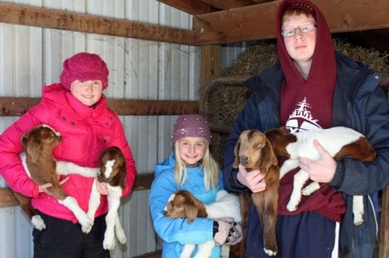 Kara, Megan and Cameron O'Day and baby goats.