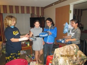 Troop 41097 sort through all the donations they received at the Chelsea Comfort Inn during a sorting party.