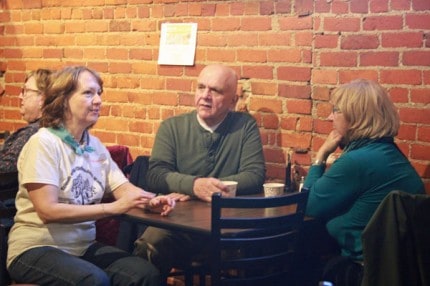 Several of the event sponsors Stephanie Doll, Pat and Sandy Merkel, talk during the Yellow Door fundraiser for the Chelsea Farmers' Markets.