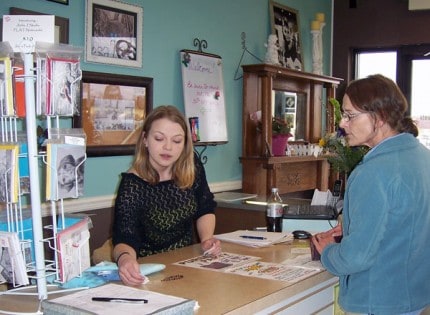 Photo by Lisa Carolin. Stephanie Merkel, new owner of Shabby Chic, assists a customer. 